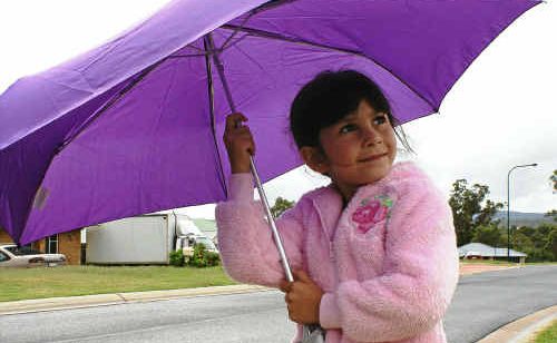 Gracie Forbes is prepared for the weather with warm clothes and an umbrella. Gracie Forbes is prepared for the weather with warm clothes and an umbrella.